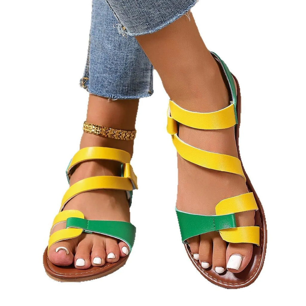 Women's flat sandals with velcro strap showing round toe design and rubber sole