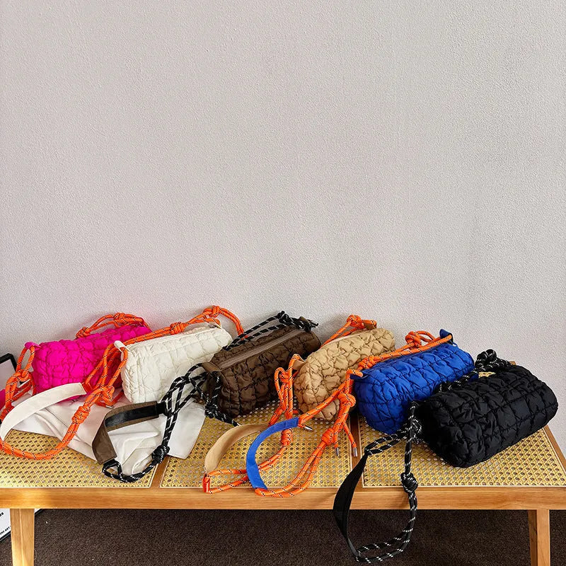 Soft nylon women's crossbody messenger bag in pillow shape with a rhombus pattern and a zippered inner pocket.