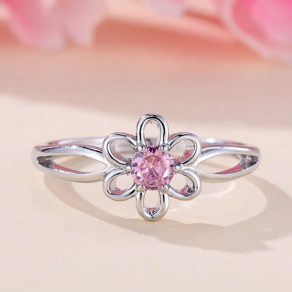 Lady's copper ring with hollowed flower design in platinum pink diamond colour showing size options