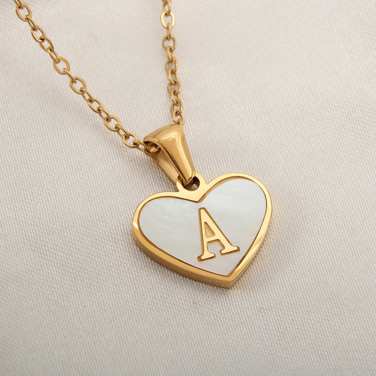 Gold plated heart necklace with white shell detail on an adjustable chain