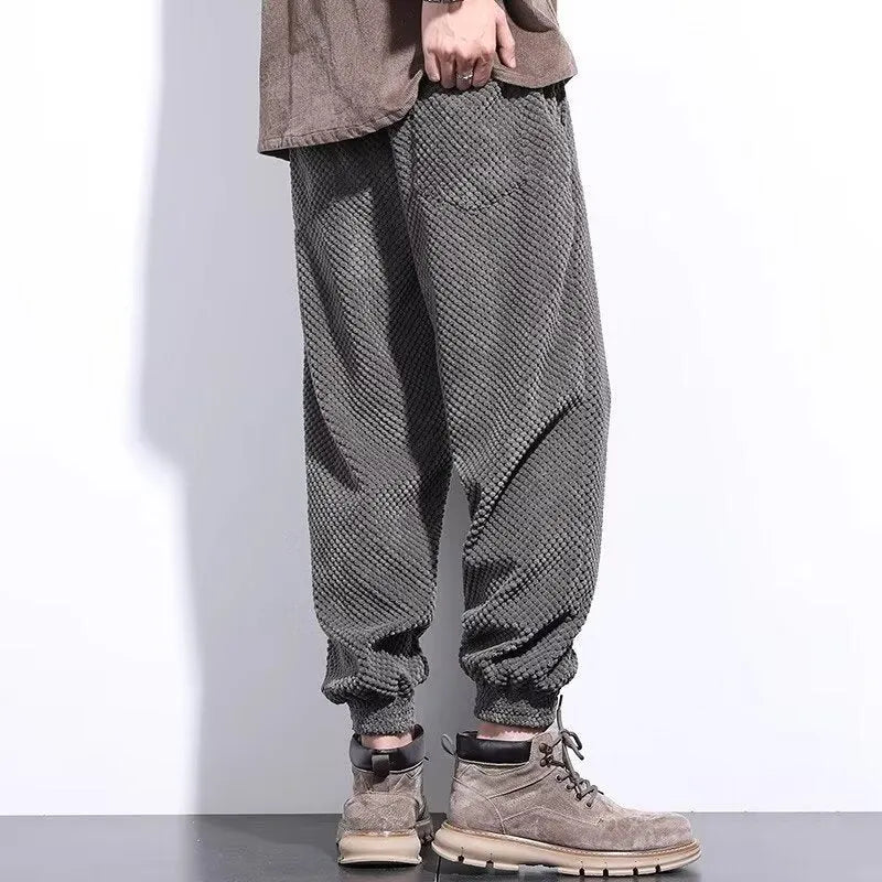 Men's grey straight-leg sweatpants with ankle ties on a hanger