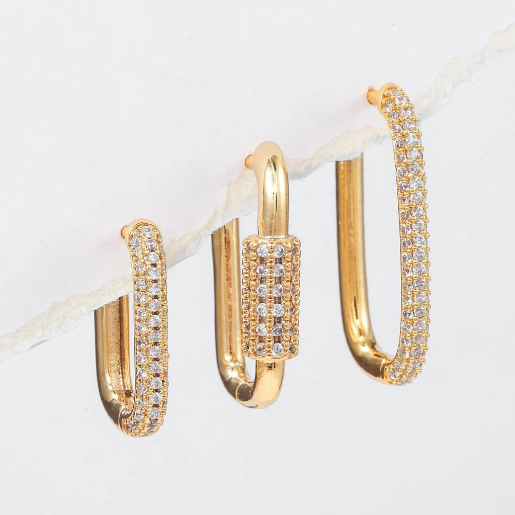 Three geometric copper ear clips with micro inlaid zircon detailing in gold and white finishes