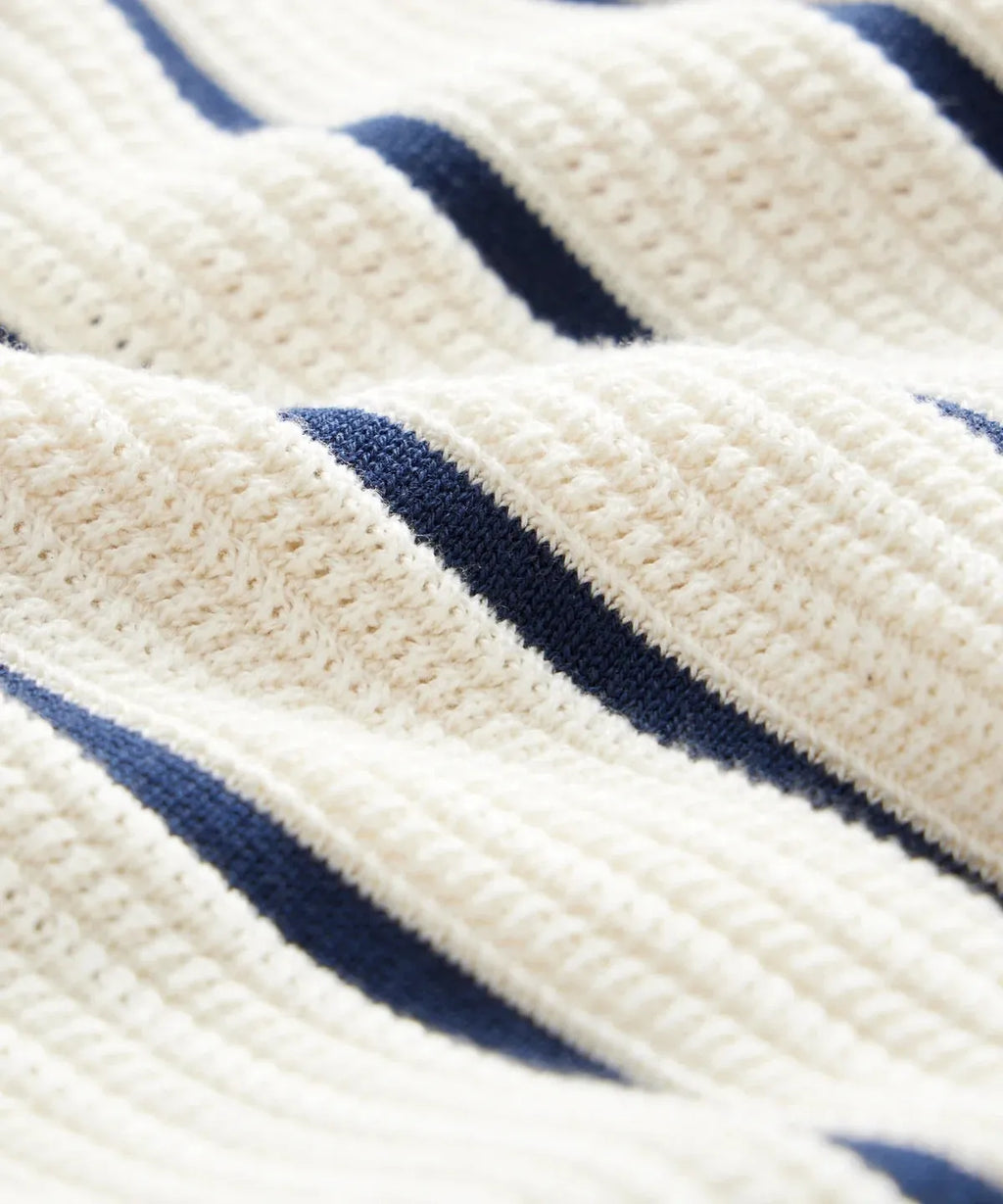 Men's white short sleeve knitted top with an asymmetrical lapel, made from ice silk spandex fabric.