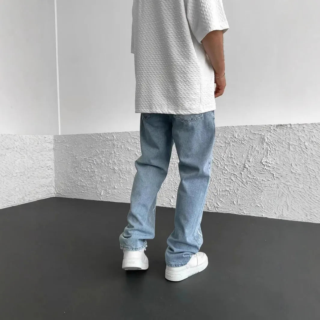 Men's blue straight-leg denim jeans with wide-leg silhouette and mid-waist design