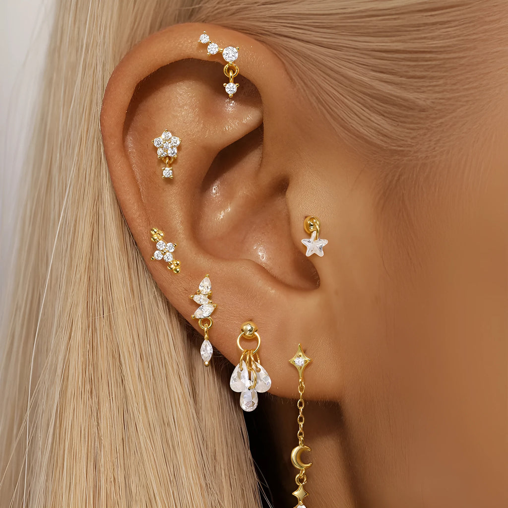 S925 sterling silver geometric earring with embedded moon, star, and diamond design on a gold-coloured background.