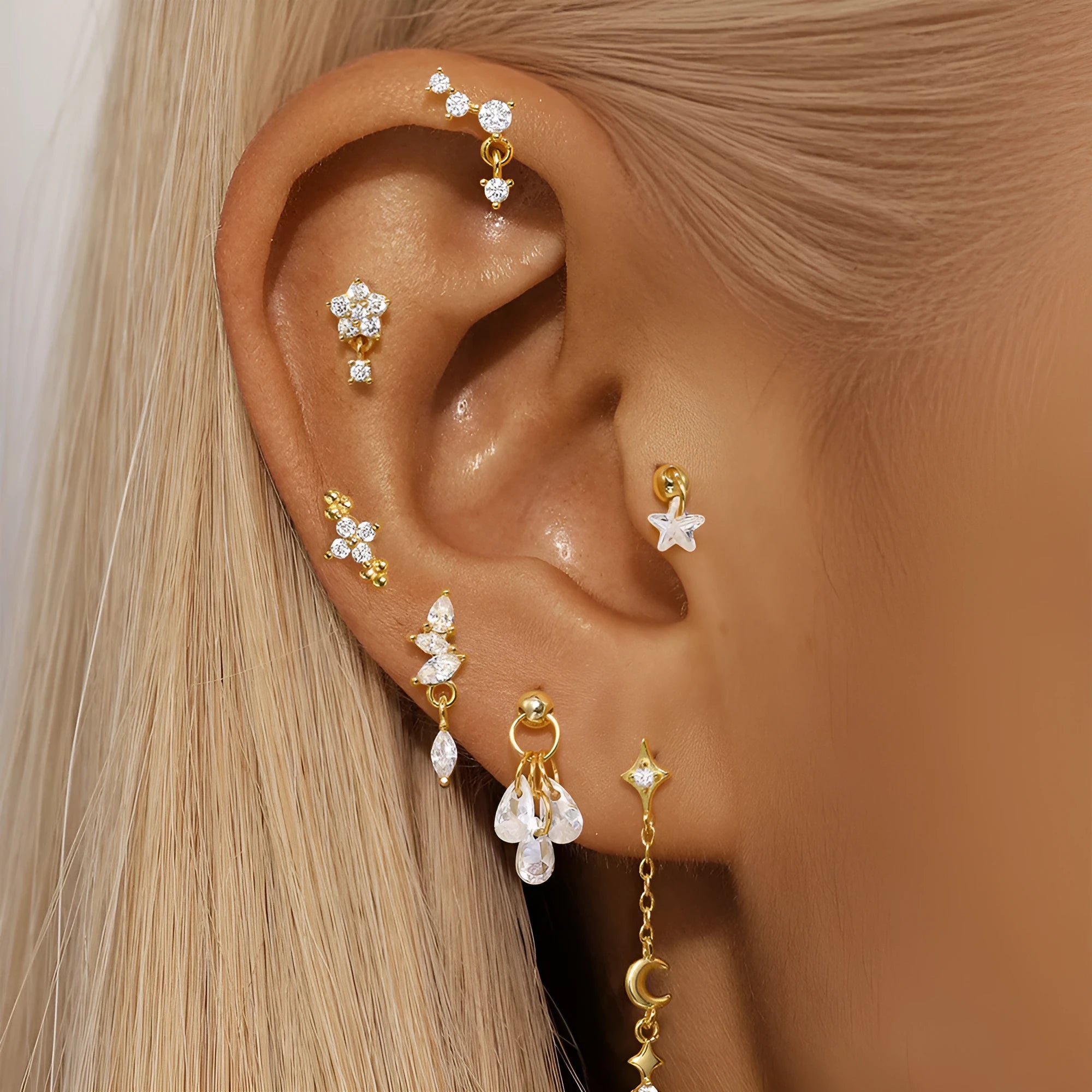 S925 sterling silver geometric earring with embedded moon, star, and diamond design on a gold-coloured background.