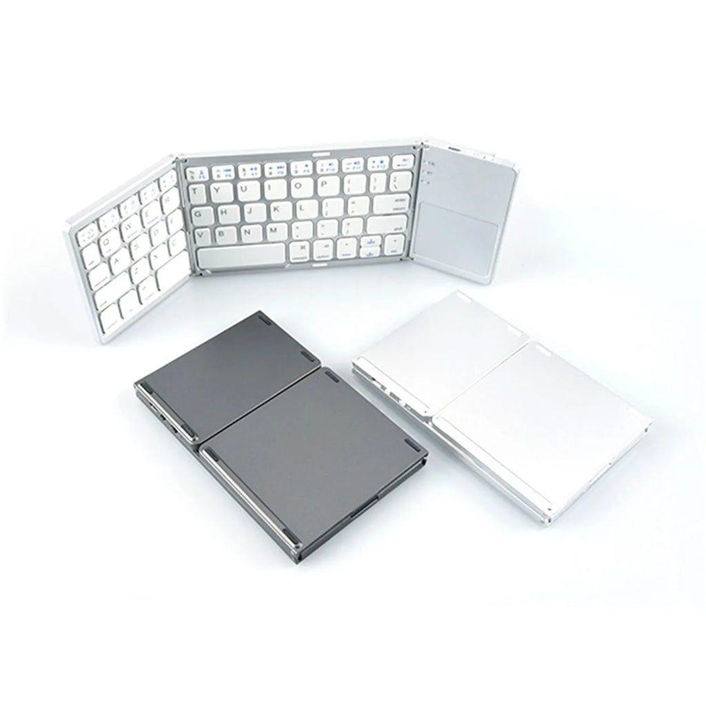 Black tri-fold portable Bluetooth keyboard shown open next to a smartphone, demonstrating its compact size.