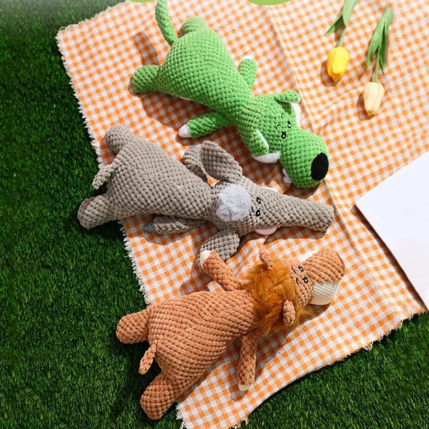 Green plush dog toy shaped like corn with textured kernel surface and squeaker inside