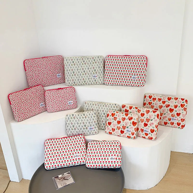 Cloth laptop bag in floral and heart patterns showing three size options with anti-seismic protection