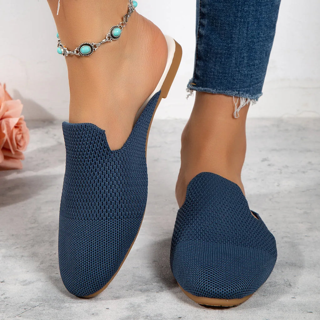 A pair of apricot-coloured mesh slip-on flat sandals with a round toe and rubber sole.