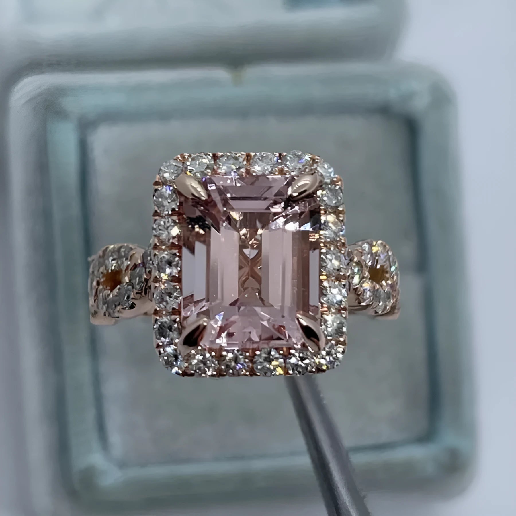 Geometric rose gold coloured alloy ring for women and men on a grey background.
