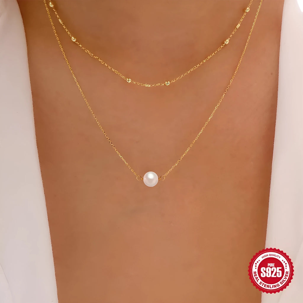 S925 sterling silver double layer necklace with twin diamond-treated pearls and geometric design.