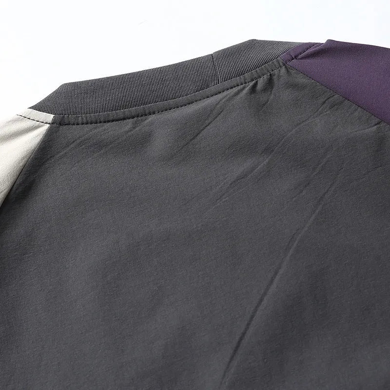 Dark grey men's loose fit t-shirt with contrasting colour raglan sleeves on a hanger.