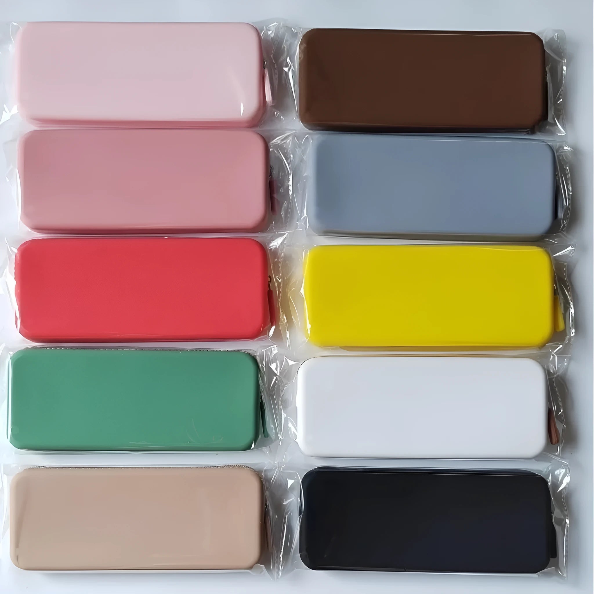 Silicone dustproof makeup brush storage bag in various colours, showing compact size.
