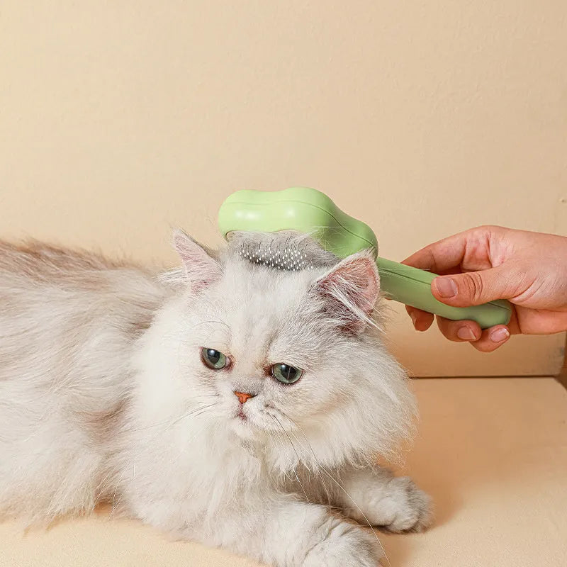Green and yellow self-cleaning stainless steel cat comb grooming tool measuring 20 cm.