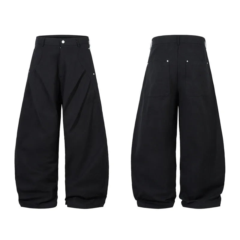 Men's black cotton trousers with pleated machete detailing and loose-fitting wide-leg silhouette
