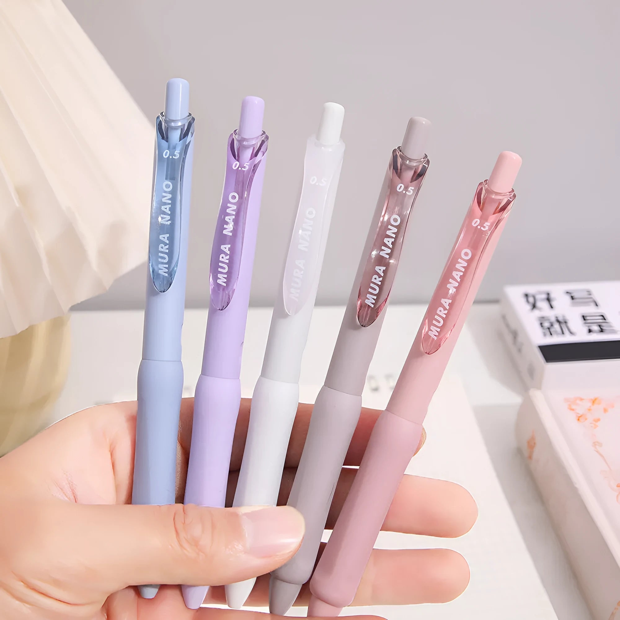 Macaron Colour press gel pen with 0.5mm tip in smoked white, brown, and pink options.