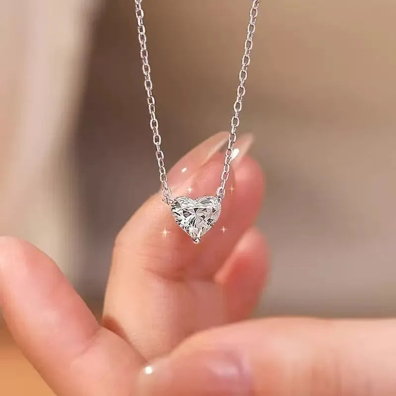 Silver-coloured women's necklace with a simple heart-shaped pendant on a chain.