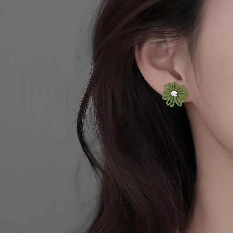 Women's alloy cartoon flower stud earrings showing blue and orange, white and green, and yellow and white colour combinations