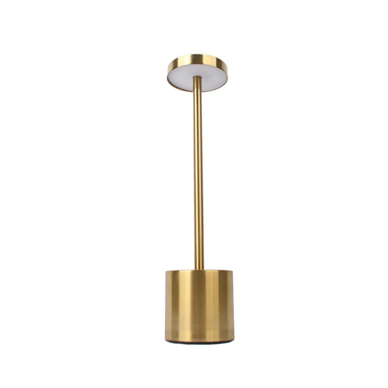 Metal touch desk lamp in gold finish with LED light on, showing compact 34x8cm size