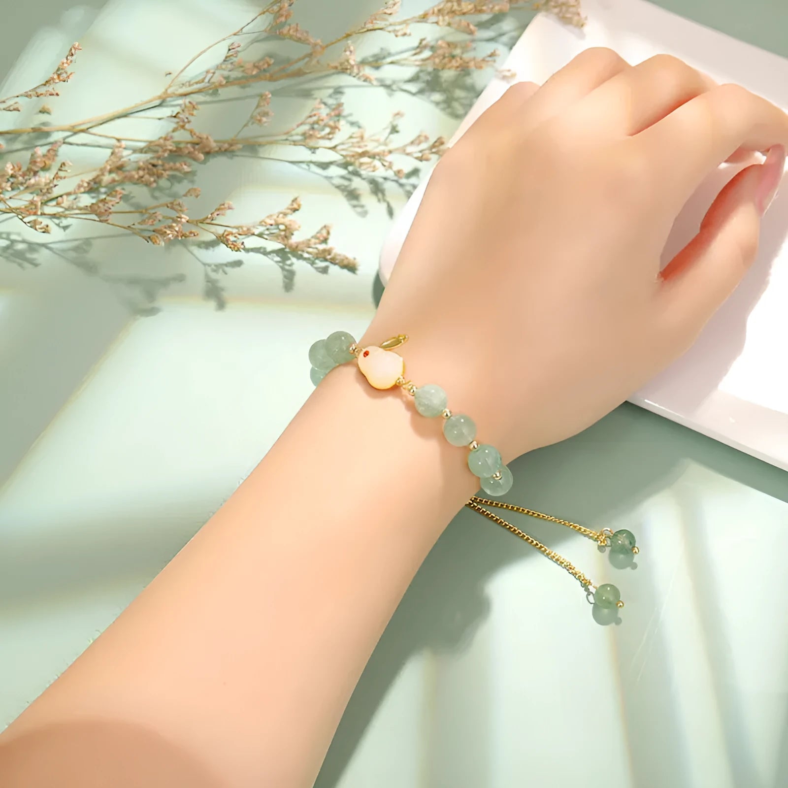 Natural stone rabbit bracelet with green aventurine and strawberry quartz beads, copper plating and gold accents