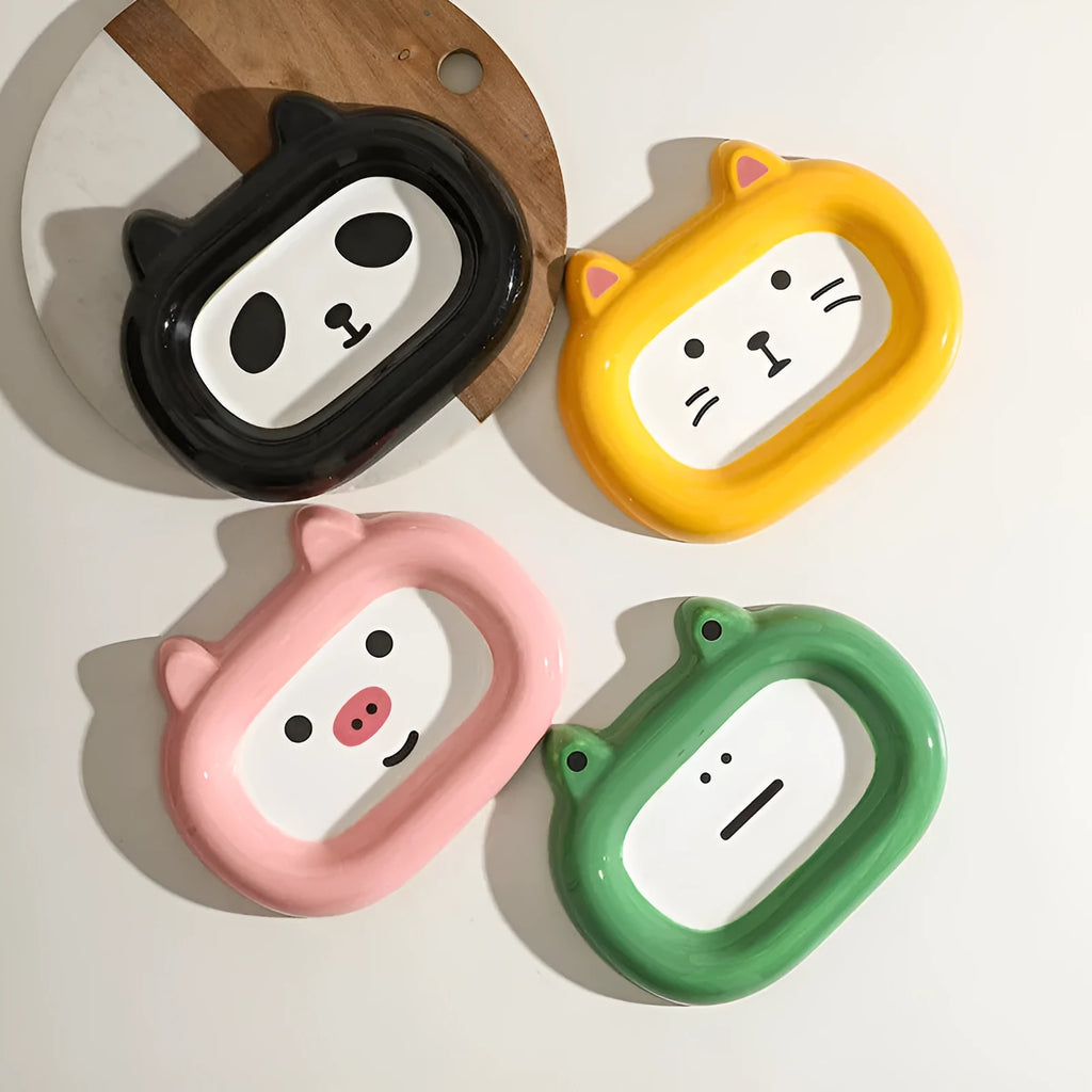 Ceramic pet bowl shaped like a cat, frog, panda, or pig for dry food or water.