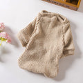 Brown cloth pullover sweater on a small dog, showing casual style.