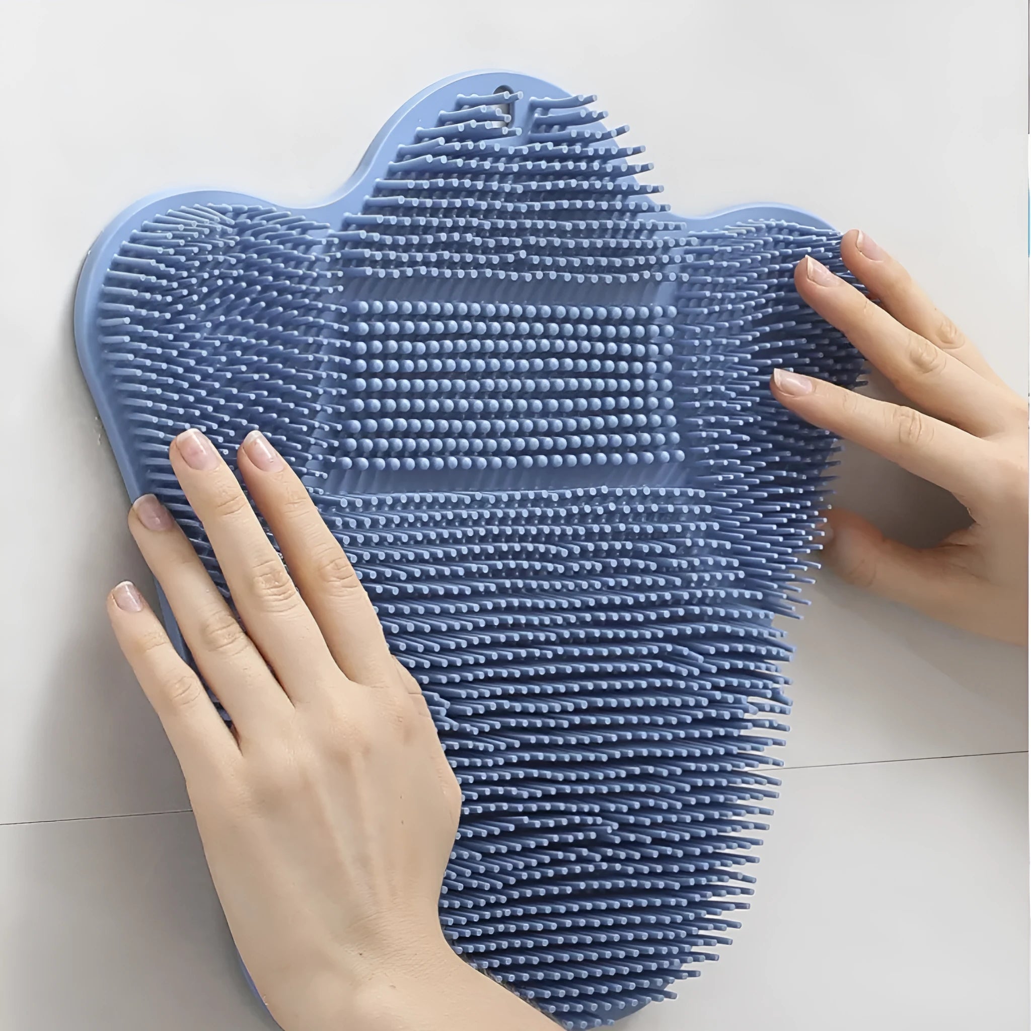 Blue silicone bath brush cushion mat for skin scrubbing measuring 31cm by 32cm