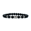 Close-up of a handcrafted tiger eye bracelet with a detailed Buddha head bead on a wrist.