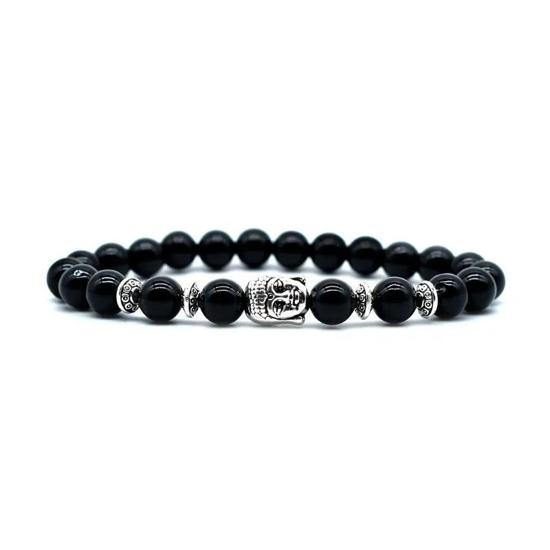 Close-up of a handcrafted tiger eye bracelet with a detailed Buddha head bead on a wrist.