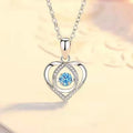 Geometric heart pendant necklace with mixed gem inlays and matching bracelet on blue background