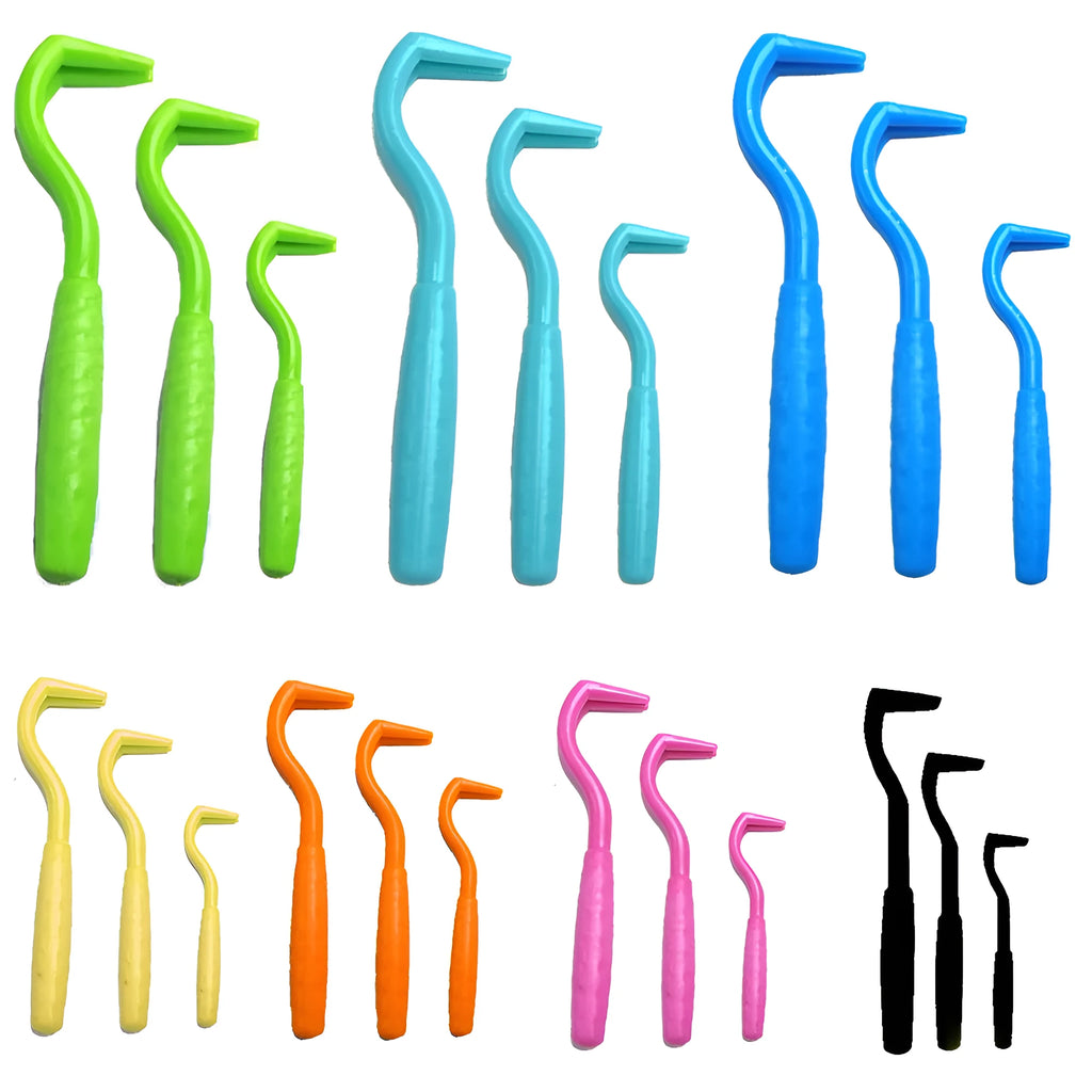 Three plastic tick hooks for dogs in various colours on white background