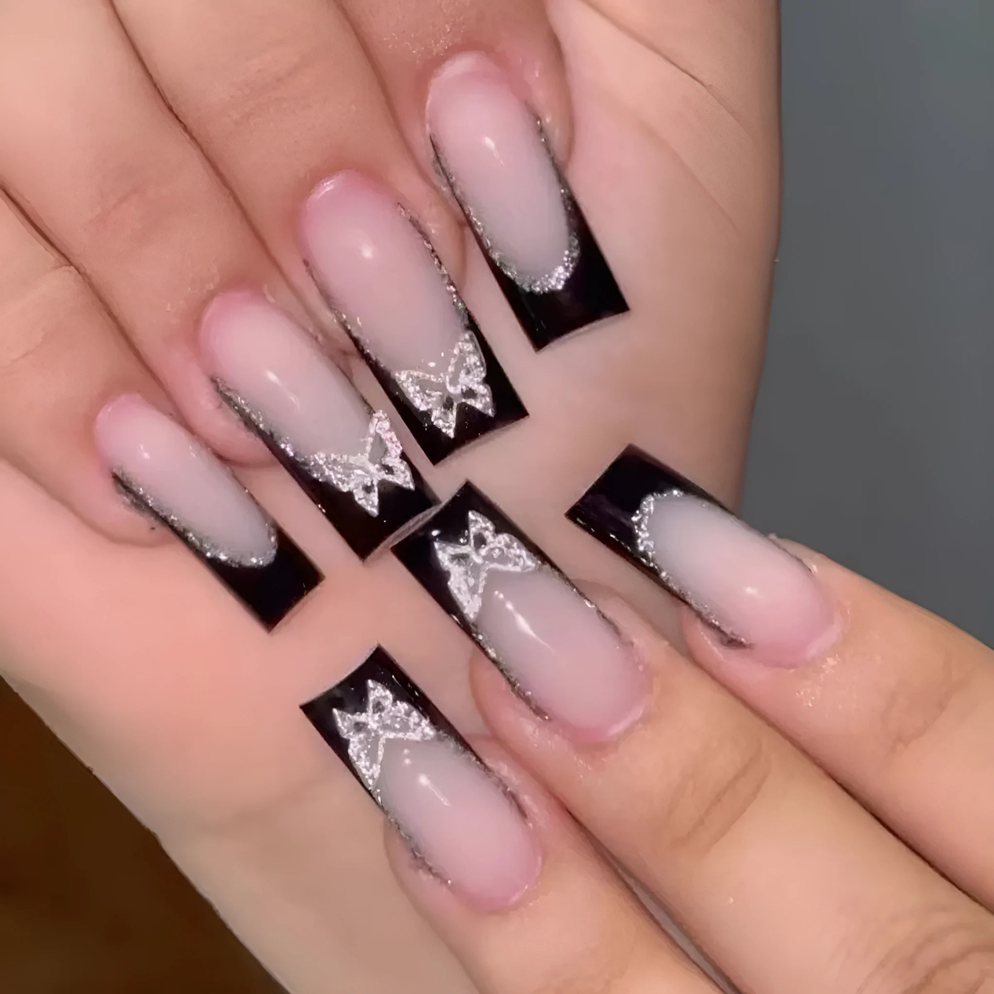 French style artificial nails with glittering butterfly pattern in medium length wearable design