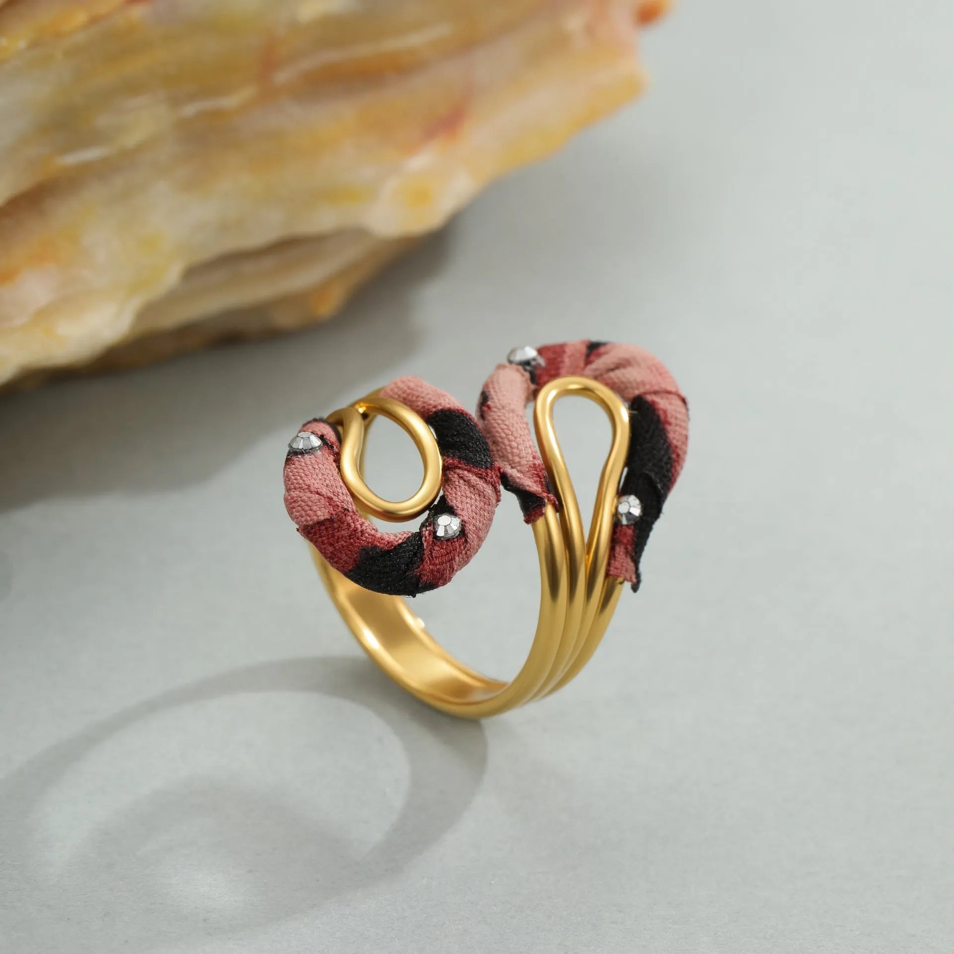 Geometric leopard print open mouth ring in stainless steel, shown in various colour options.