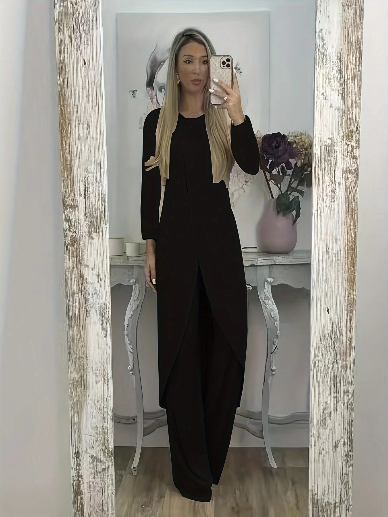 Casual long sleeve top and trousers lounge set in black, shown on a hanger
