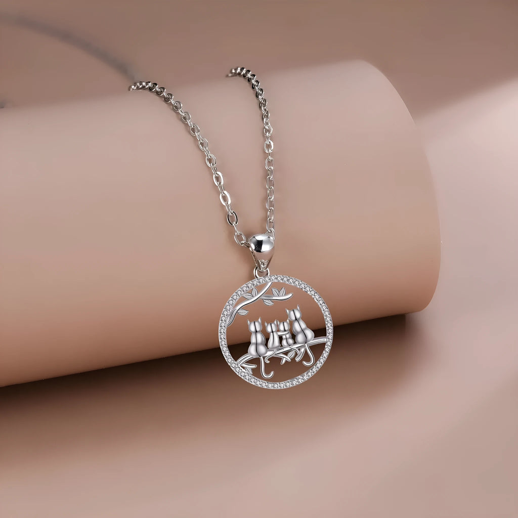 Copper necklace with a cat pendant on a cross chain, electroplated finish.