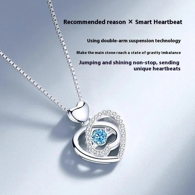 Geometric heart pendant necklace with mixed gem inlays and matching bracelet on blue background