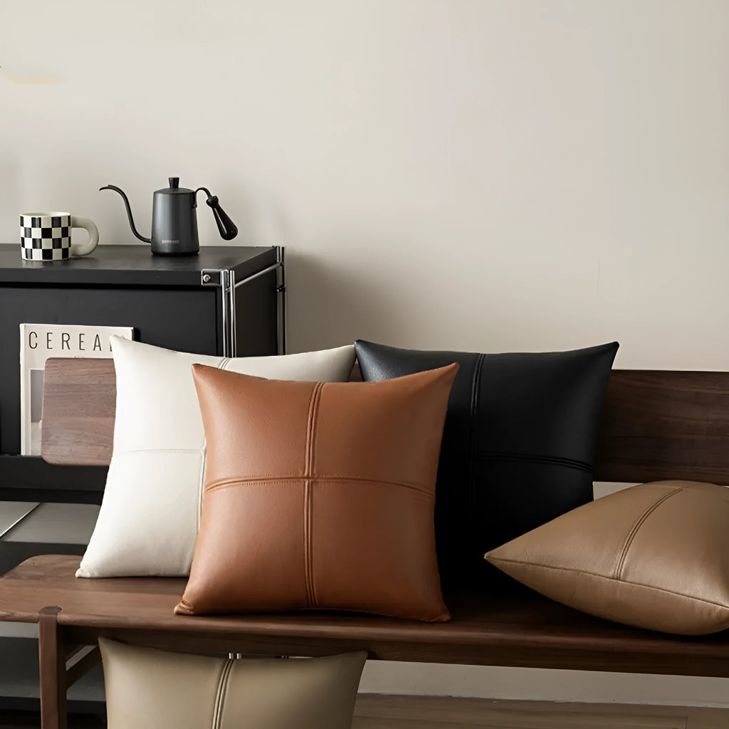Soft cowhide leather pillow cover in beige white, shown on a grey sofa.