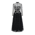 Women's long sleeve black dress with beaded decoration and a full-length skirt.