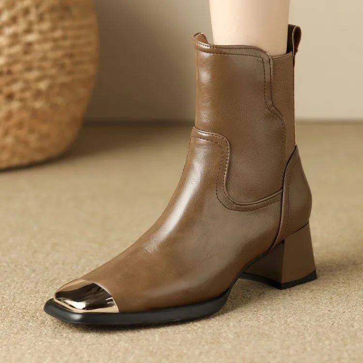 Brown leather women's Martin boots with a high heel and side zipper on a white background.