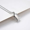 Silver coloured curved peach heart pendant necklace on a stainless steel chain with extension.