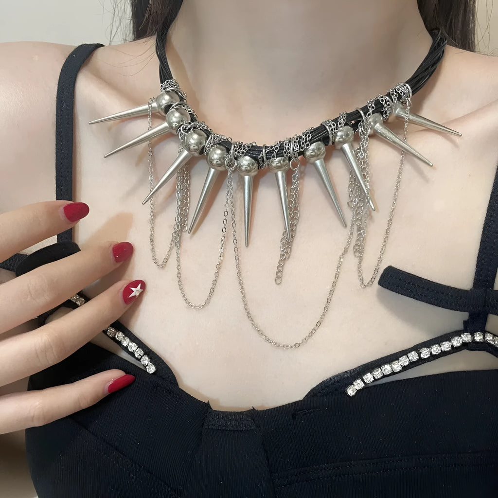 Women's leather necklace with winding beads, a tassel, and metallic point rivets.