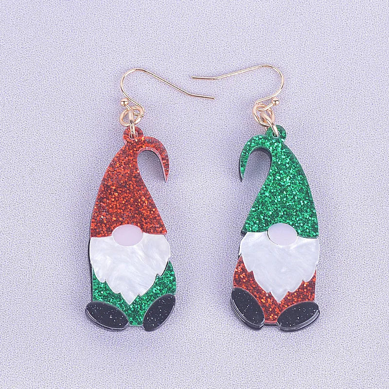 A pair of acrylic earrings shaped like cartoon Santa Claus figures with coloured hats.
