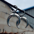 Silver geometric hoop earrings with moon detail and clip fastening