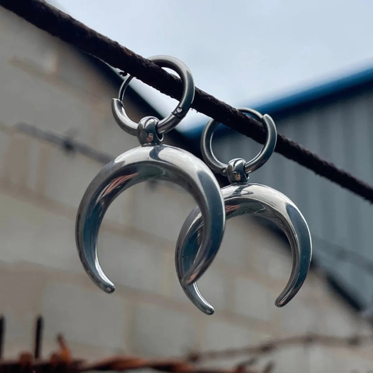 Silver geometric hoop earrings with moon detail and clip fastening