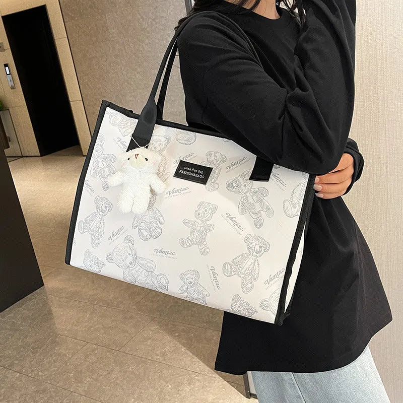 Women's black canvas tote bag with rhombus pattern and shoulder strap