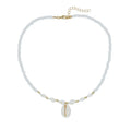Close-up of a white conch shell necklace pendant made from Mother Pearl on a silver-toned chain.