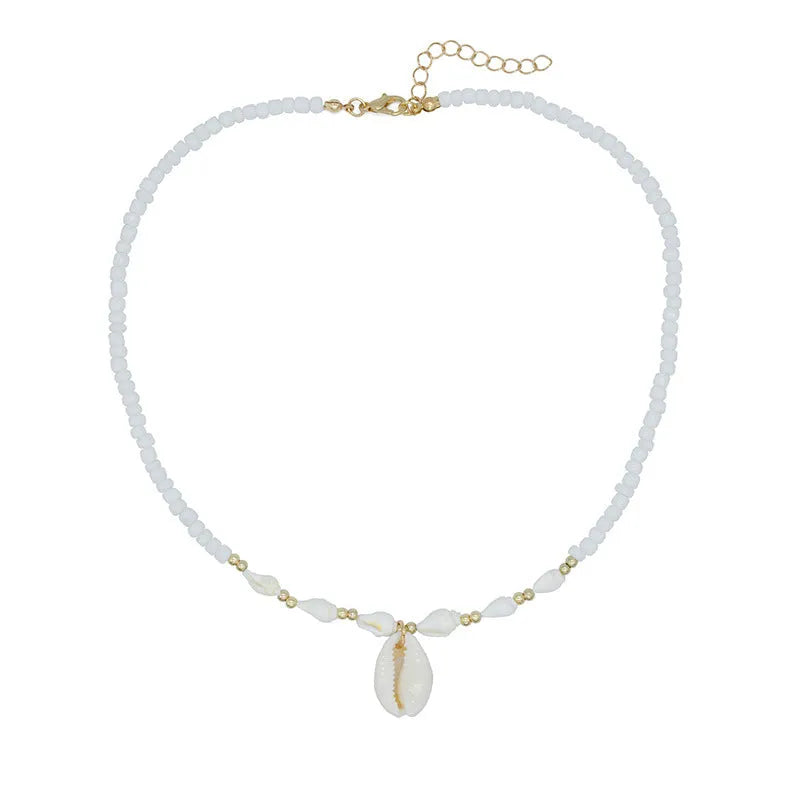 Close-up of a white conch shell necklace pendant made from Mother Pearl on a silver-toned chain.
