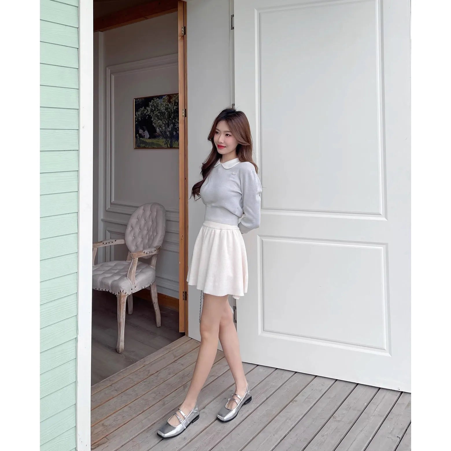 Women's silver genuine leather ballet flats with a cross buckle strap and flat sole.