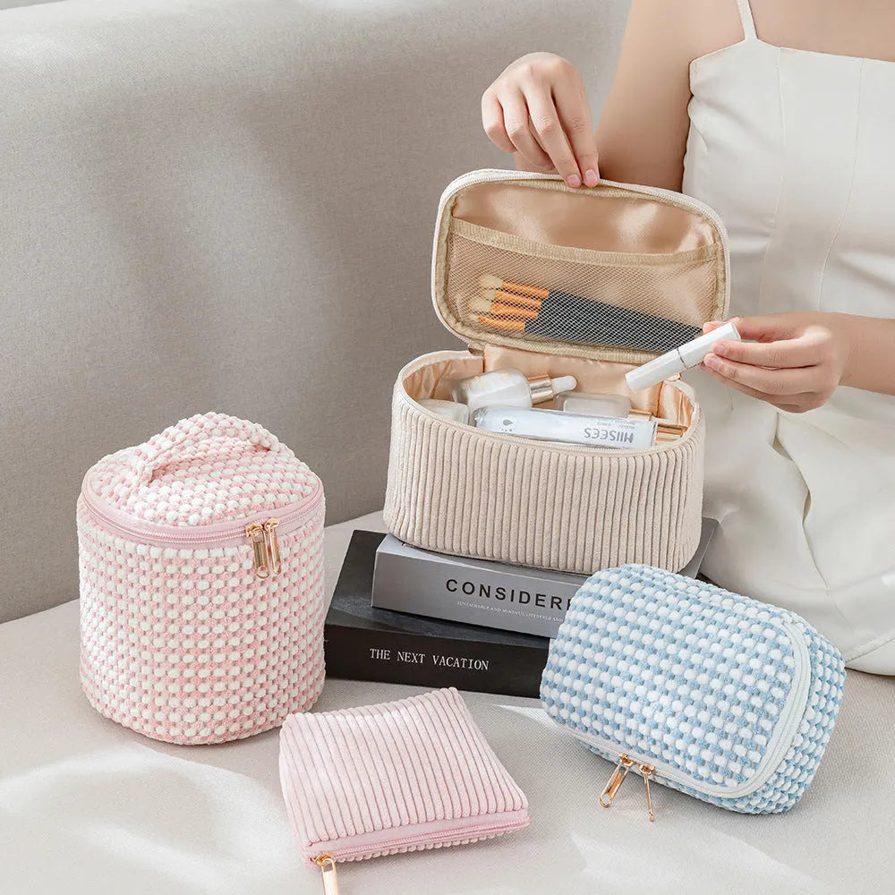 Four cube makeup bags in blue with dots pattern arranged as travel set